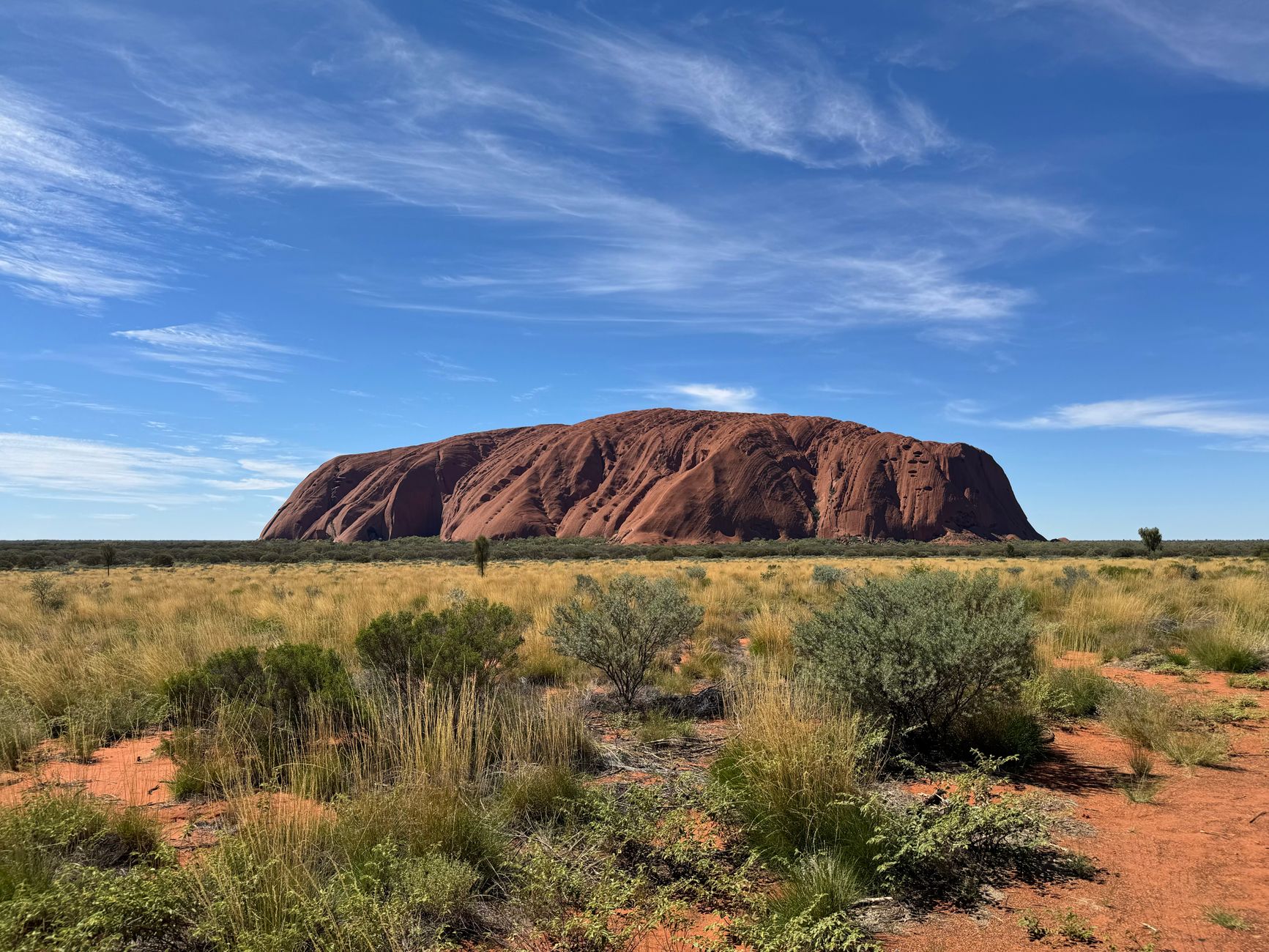 Uluru monolith rising from the red desert of the Australian outback, Northern Territory