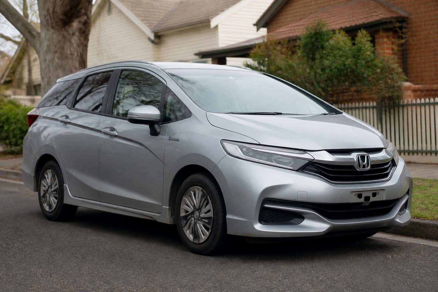 2020 Honda Shuttle GP7 hybrid wagon in white, front three-quarter view