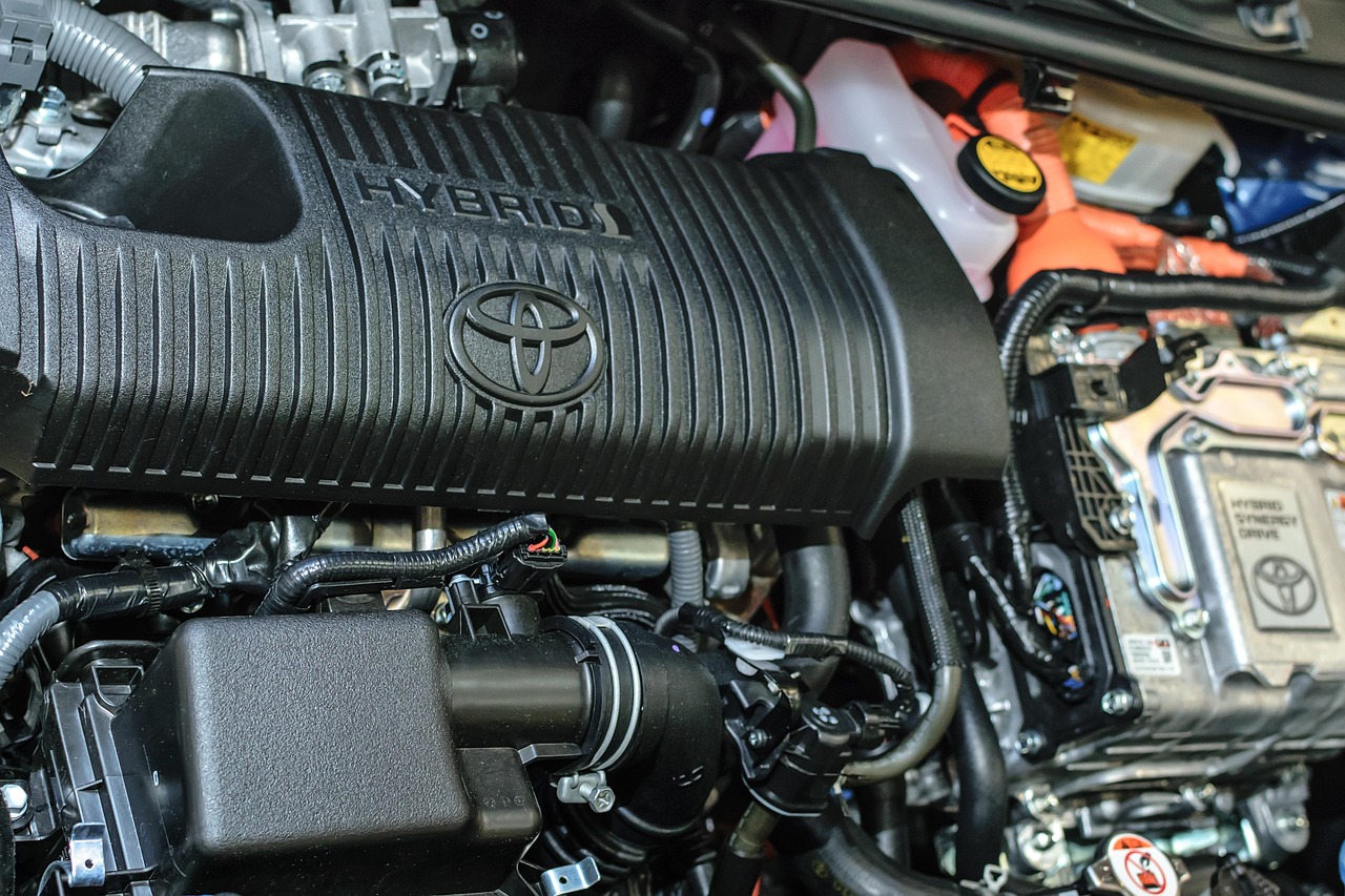 Toyota hybrid engine bay with HYBRID text, Toyota emblem, wiring and inverter components