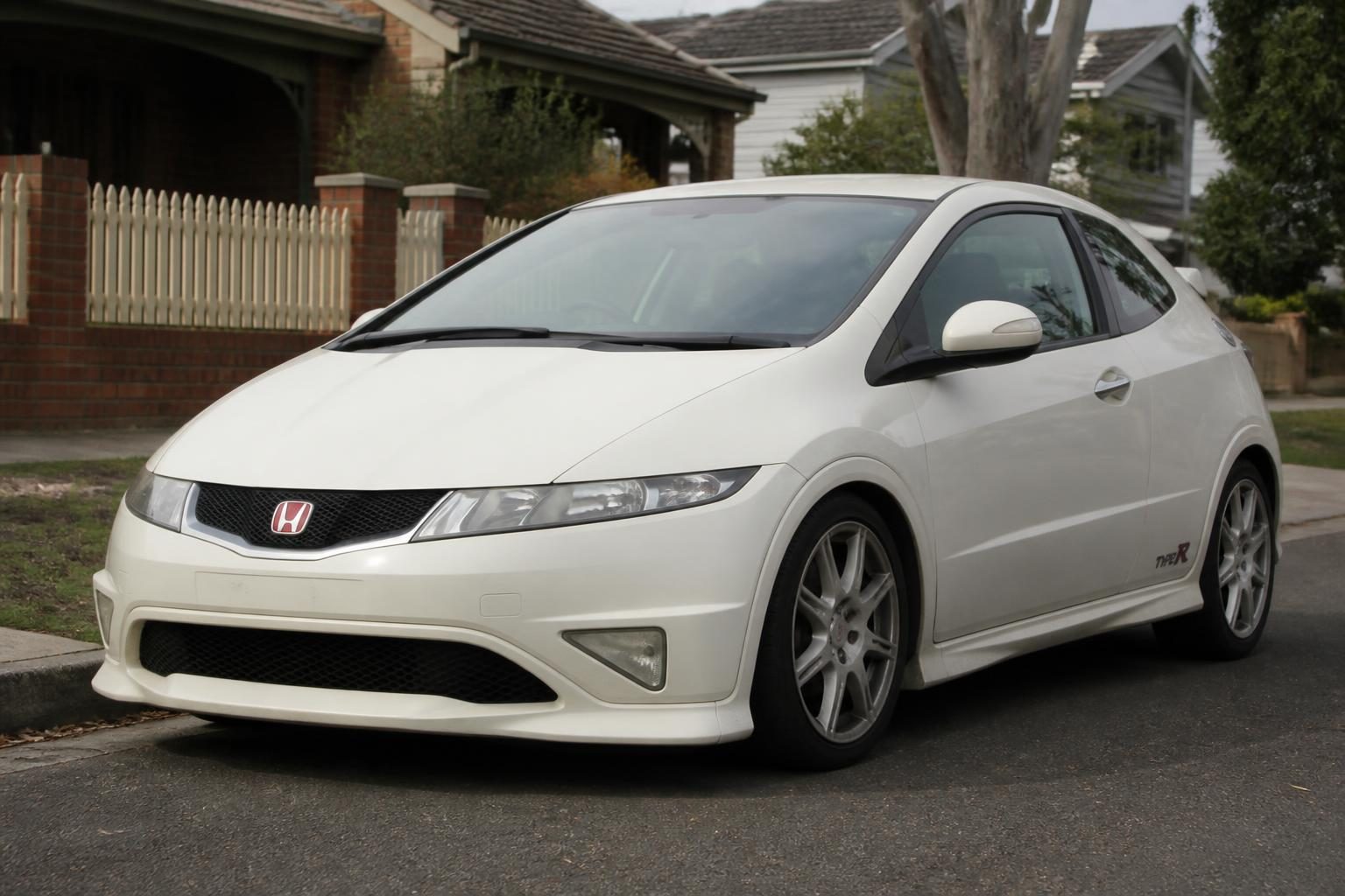 Honda Civic Type R FD2 four-door sedan at a three-quarter front angle, Type R badging visible.