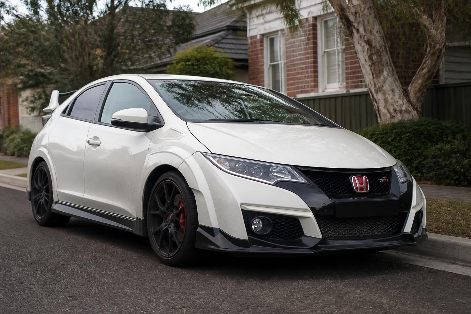 Honda Civic Type R FK2 five-door hatchback at a three-quarter front angle, showing the sport front bumper and alloy wheels.