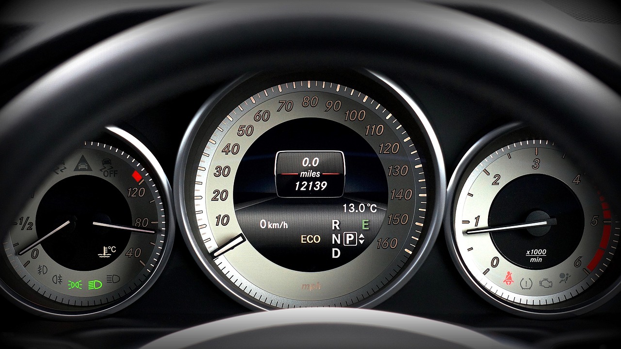 Car dashboard instrument cluster with speedometer, odometer, and gauges