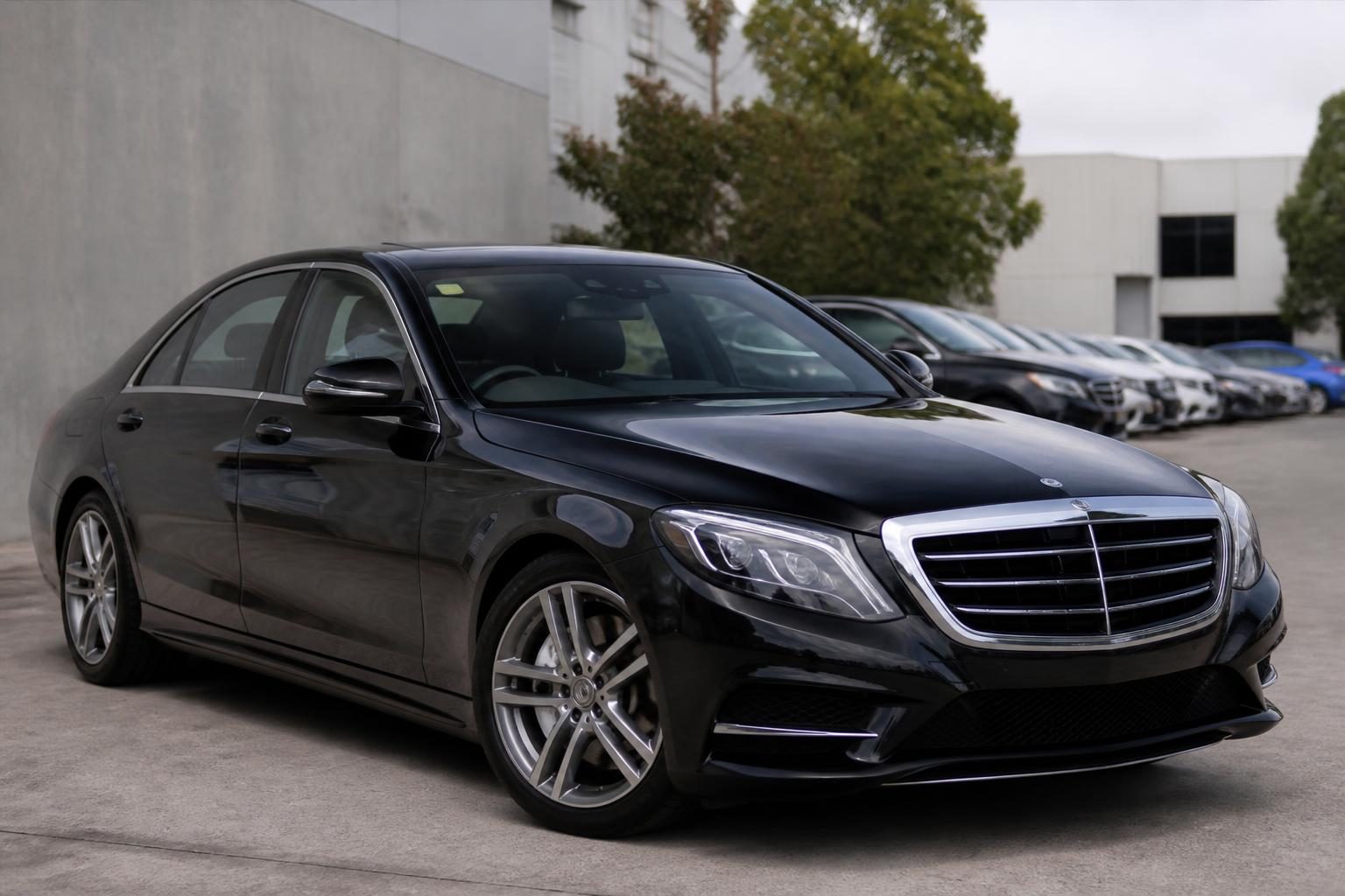 Black Mercedes-Benz S-Class sedan parked outdoors at a dealership lot