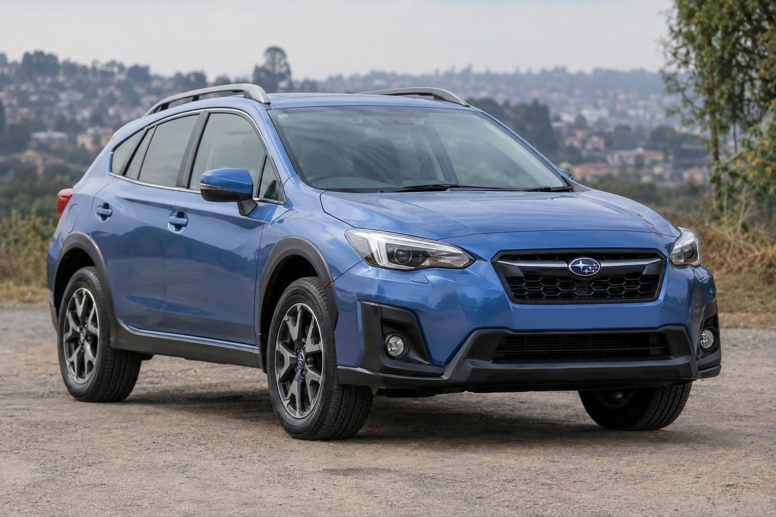 Blue second-generation Subaru XV viewed from the front three-quarter angle outdoors.