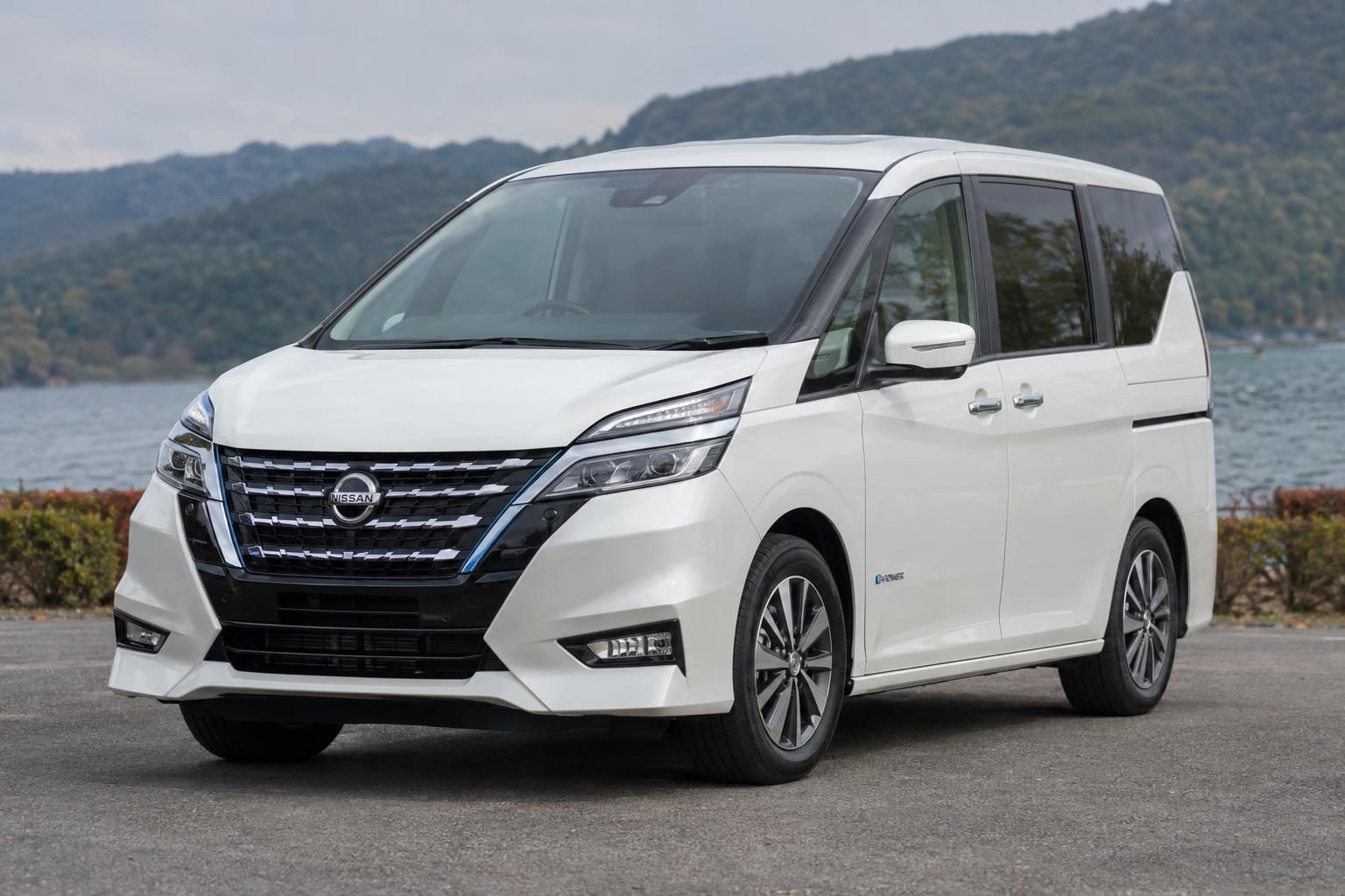 White Nissan Serena people mover parked on a leafy suburban street.