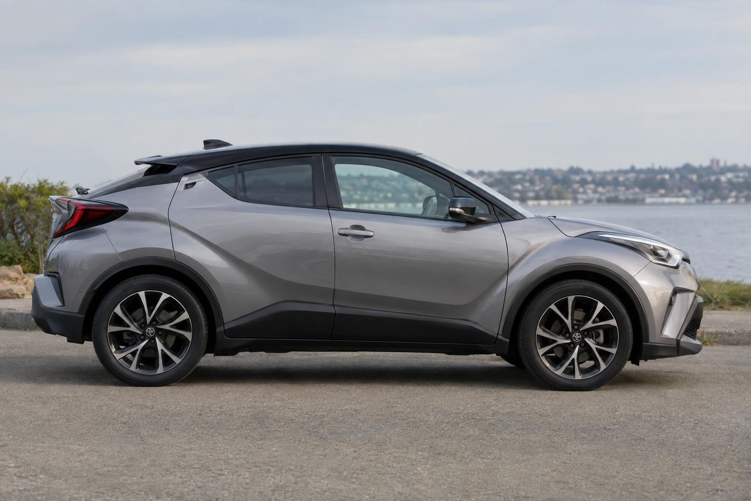 Side view of a first-generation Toyota C-HR parked beside the water.