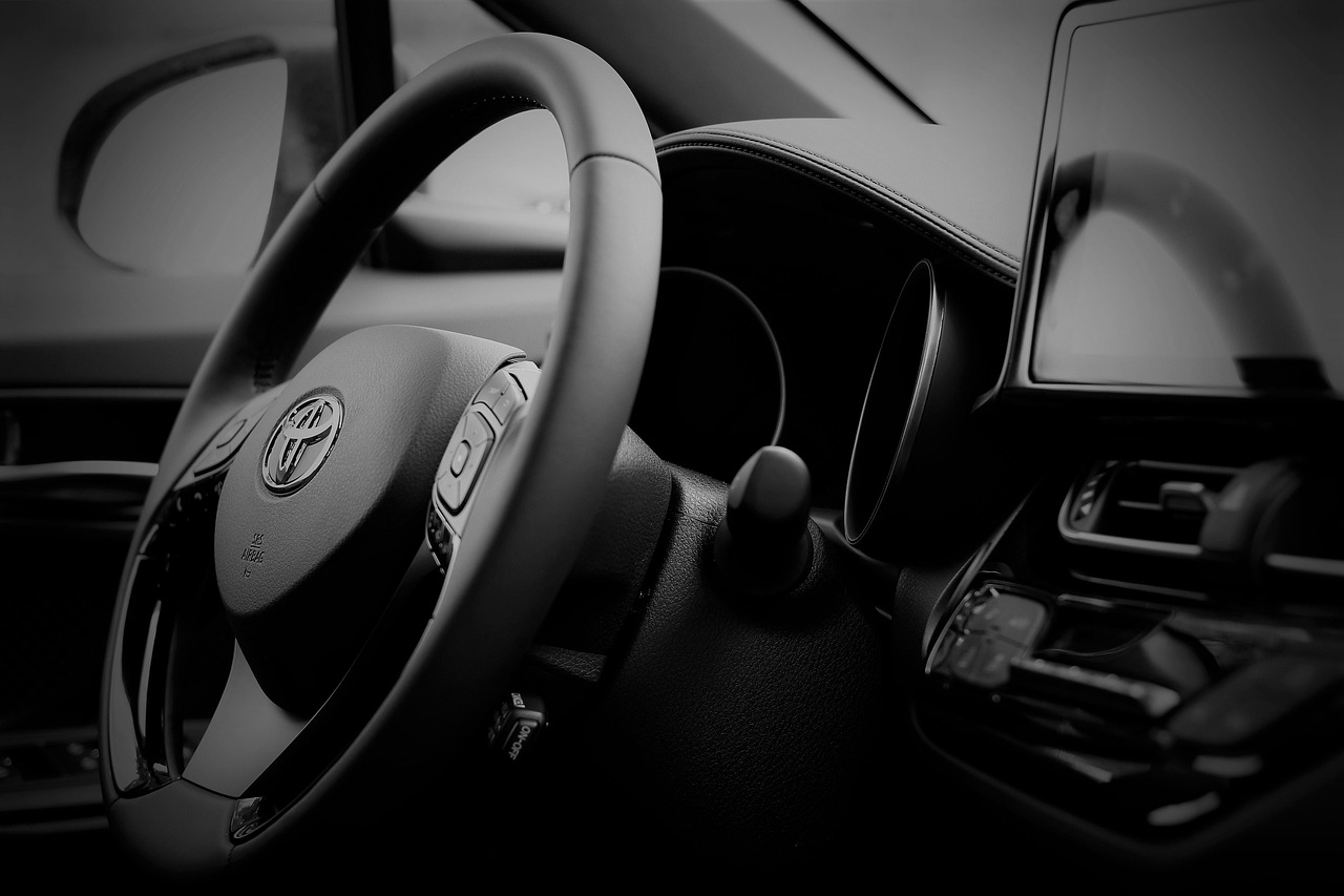 Close view of Toyota steering wheel, digital instrument cluster and center touchscreen