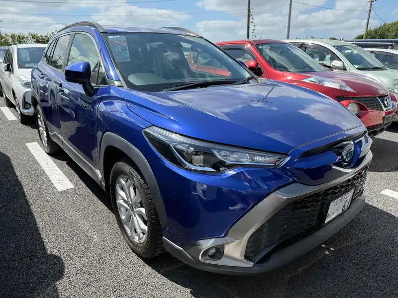 Blue Toyota Corolla Cross SUV parked in a lot, viewed from the front three-quarter angle.