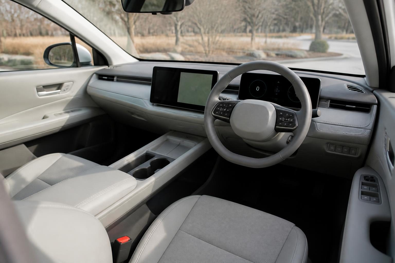 Light grey minimalist car interior with steering wheel, digital gauge display, and central touchscreen.