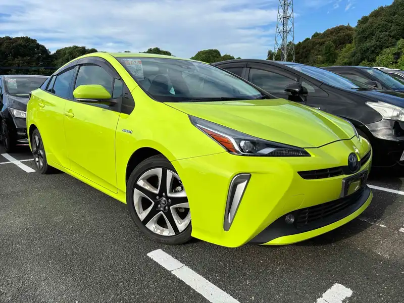 Yellow fourth-generation Toyota Prius parked in a Japanese vehicle lot.