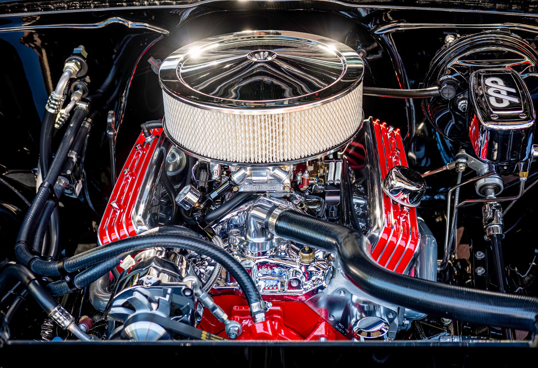 A polished V8 engine bay showing the intake manifold and cam covers