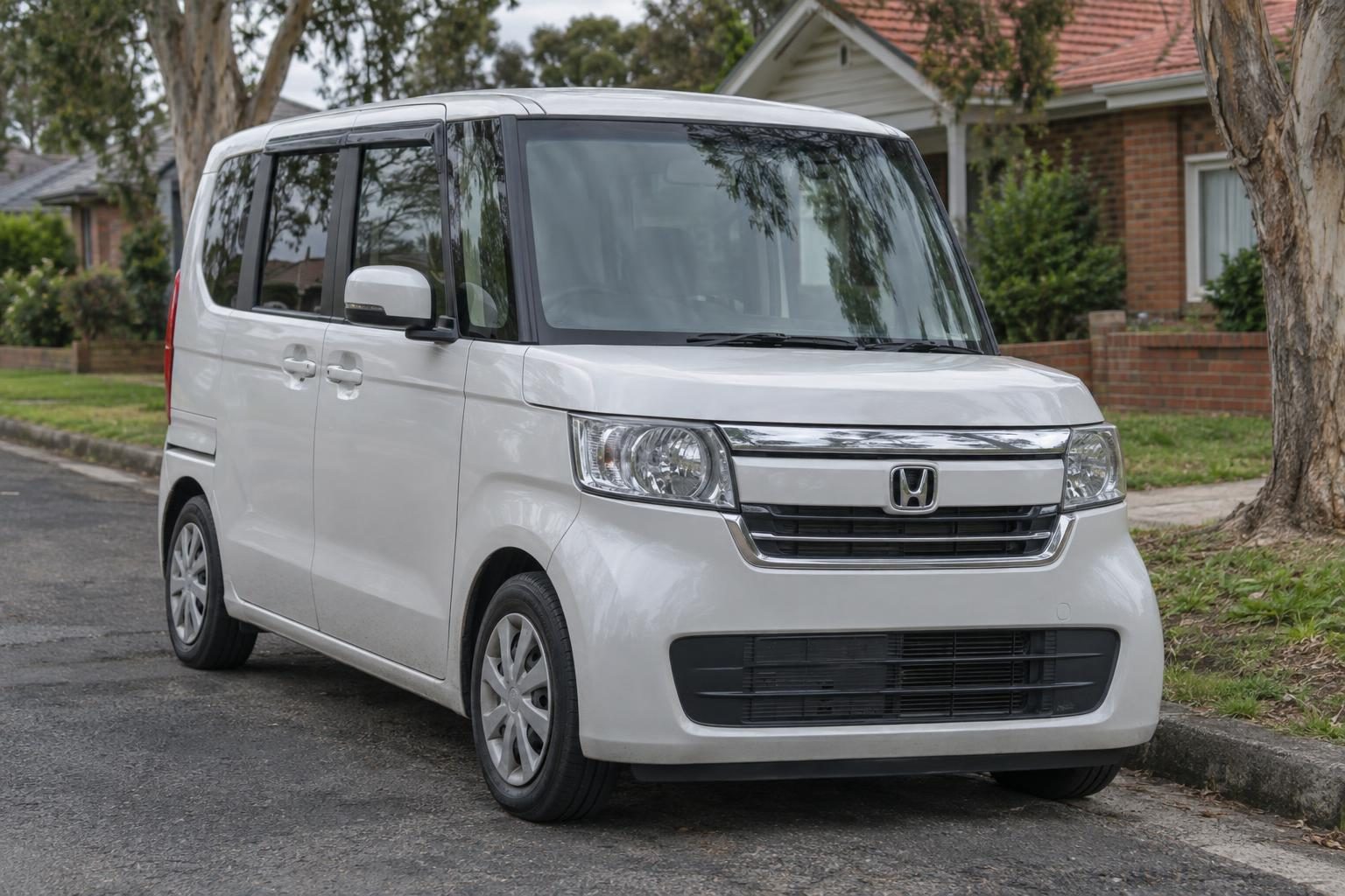 2020 Honda N-Box JF3 kei wagon front three-quarter view showing the low-mounted grille and bumper area where the condenser sits