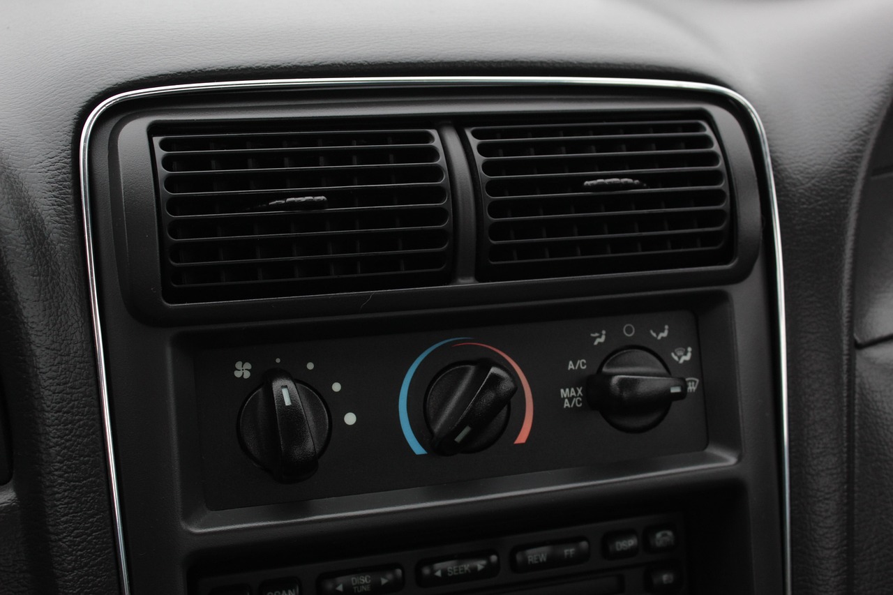 Close-up of dashboard air vents, manual climate-control dials and part of the audio unit.