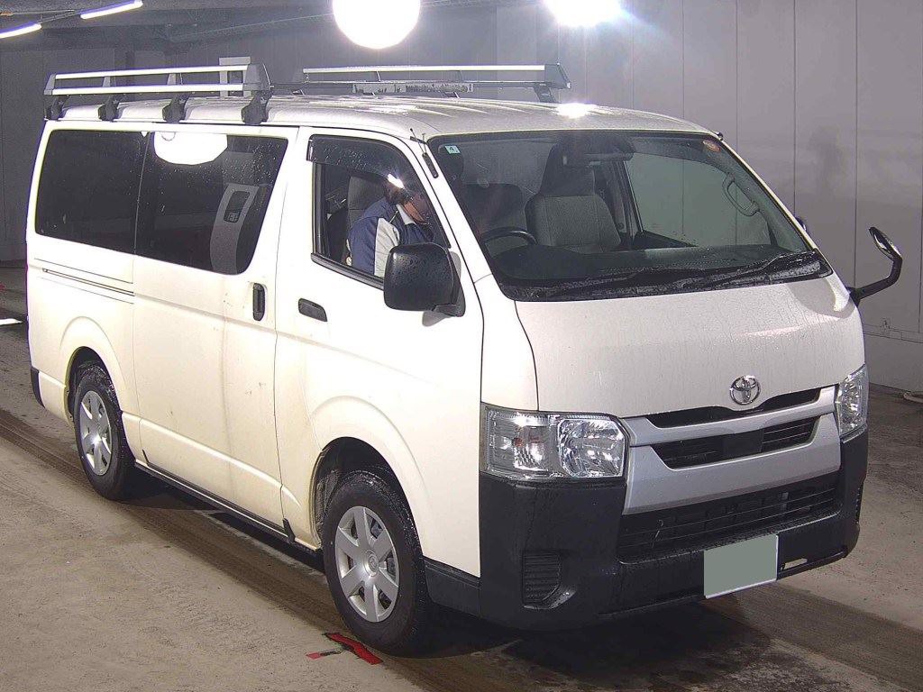 White Toyota Hiace H200 van with roof racks, shown from the front and left side.
