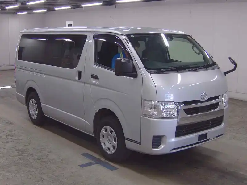Silver Toyota Hiace H200 facelift van viewed from the front and left side indoors.